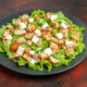 bottom-view-caesar-salad-oval-plate-dark-red-table